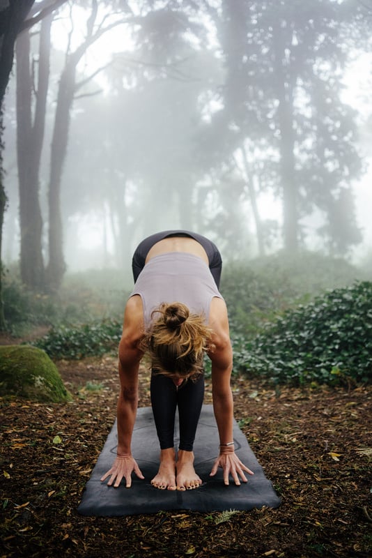 Woman Doing Yoga in Misty Forest